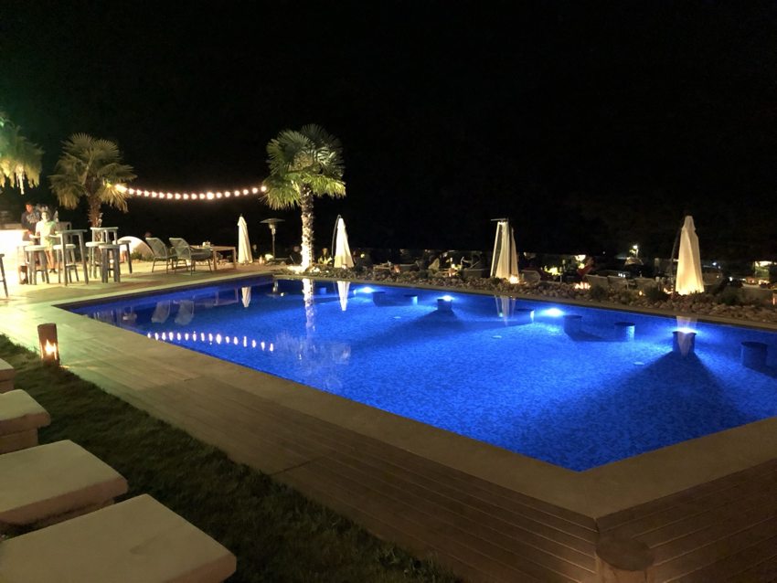 Outdoor swimming pool illuminated in blue at night